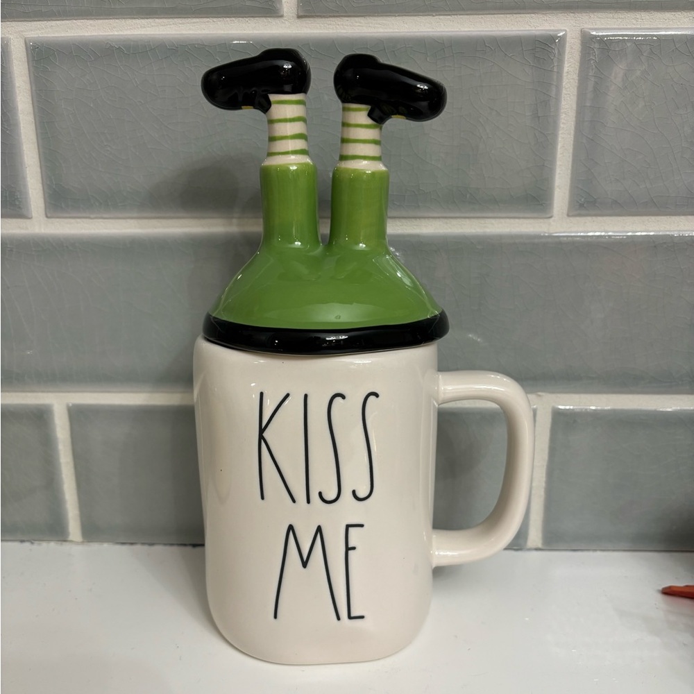 Rae Dunn St. Patrick's Day "KISS ME" mug featuring a leprechaun leg topper